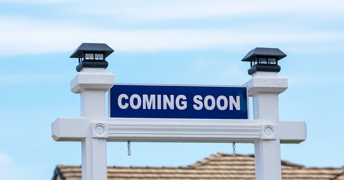 A coming soon real estate sign in front of a home